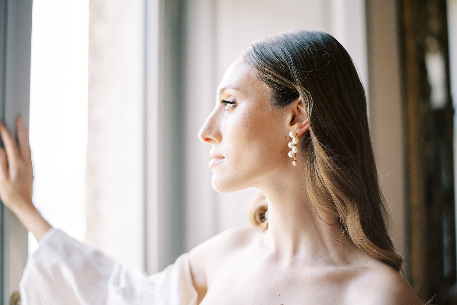 classic bridal look for woman looking out window of Italian villa
