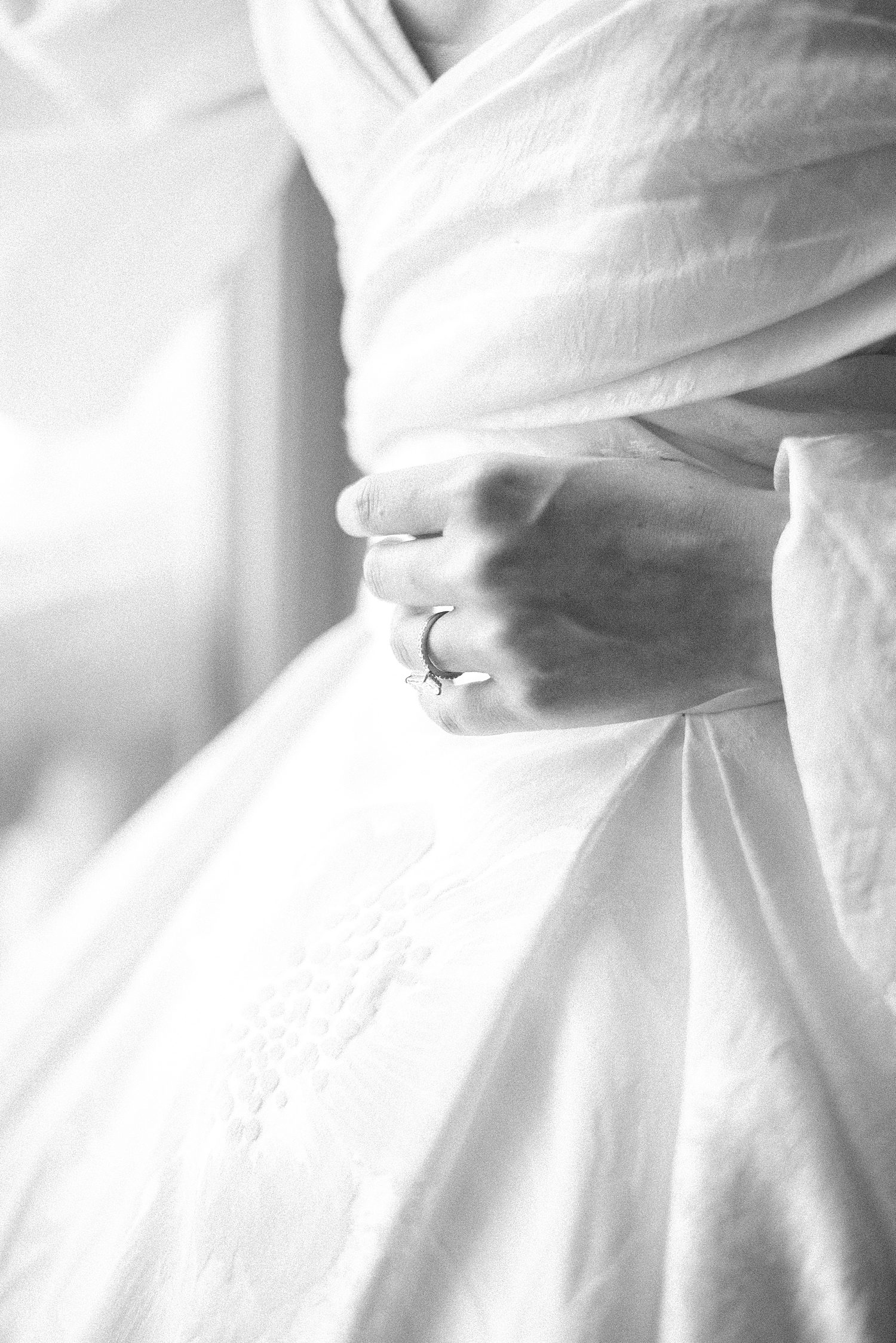 black and white portrait of bride showing off engagement ring 