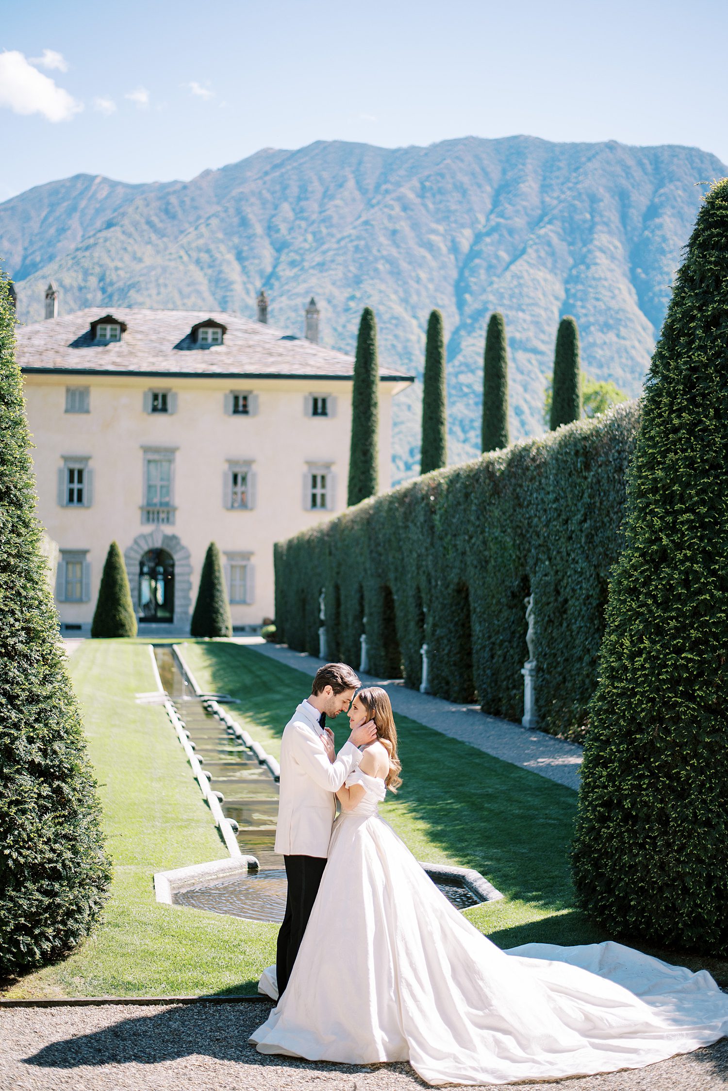bride and groom hug in front of Villa Balbiano