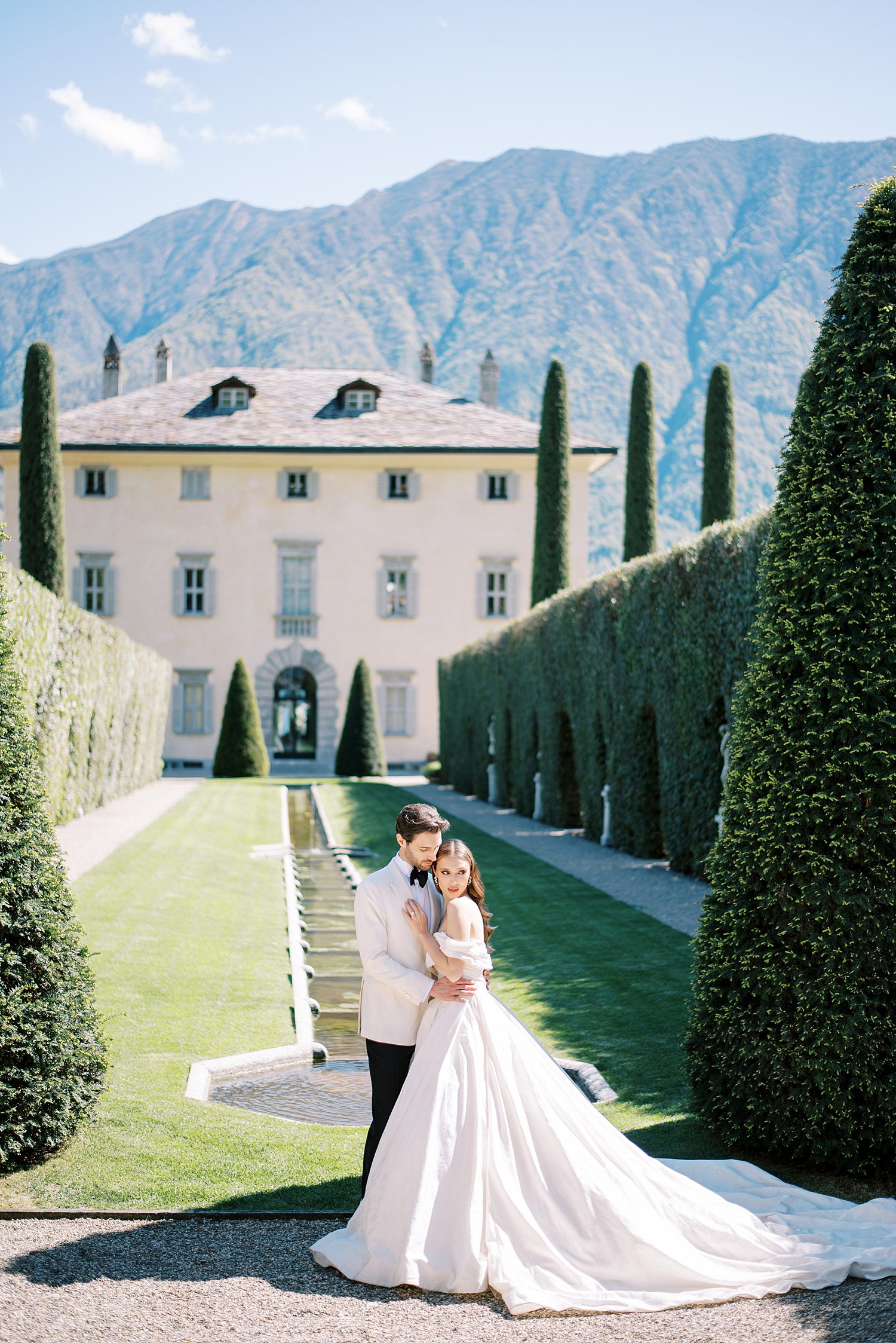 bride and groom hug in front of Villa Balbiano on Lake Como