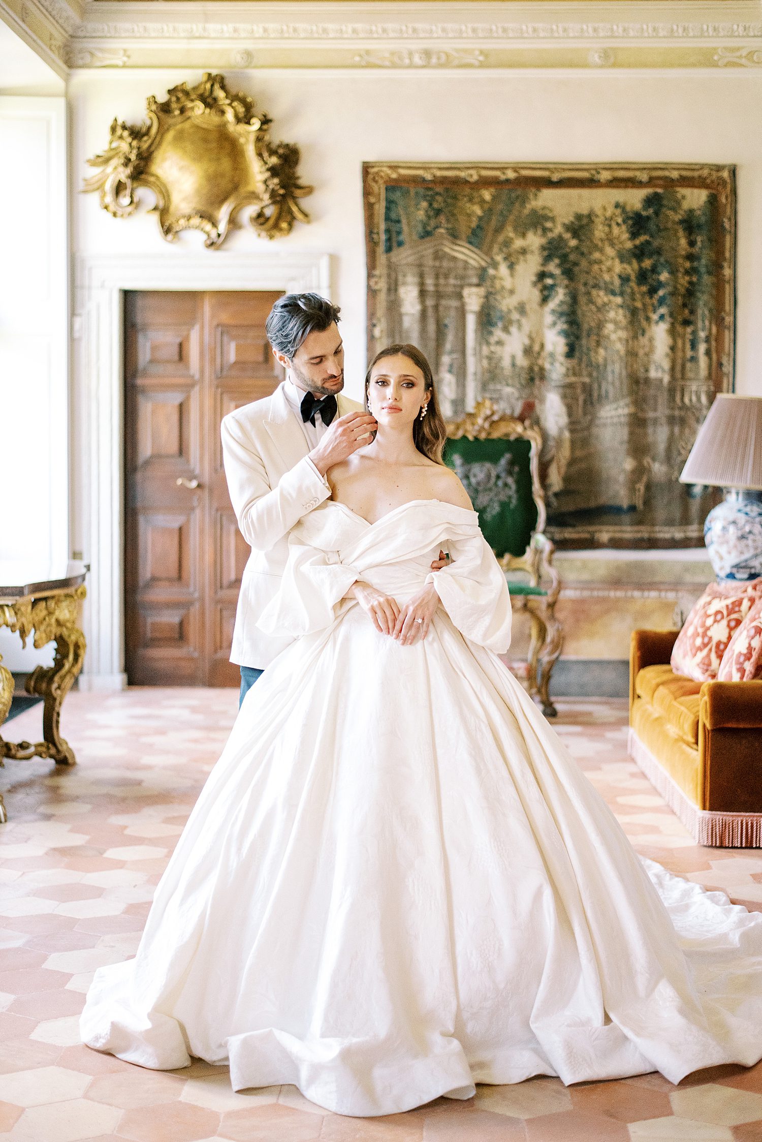 bride and groom hug inside room at Villa Balbiano