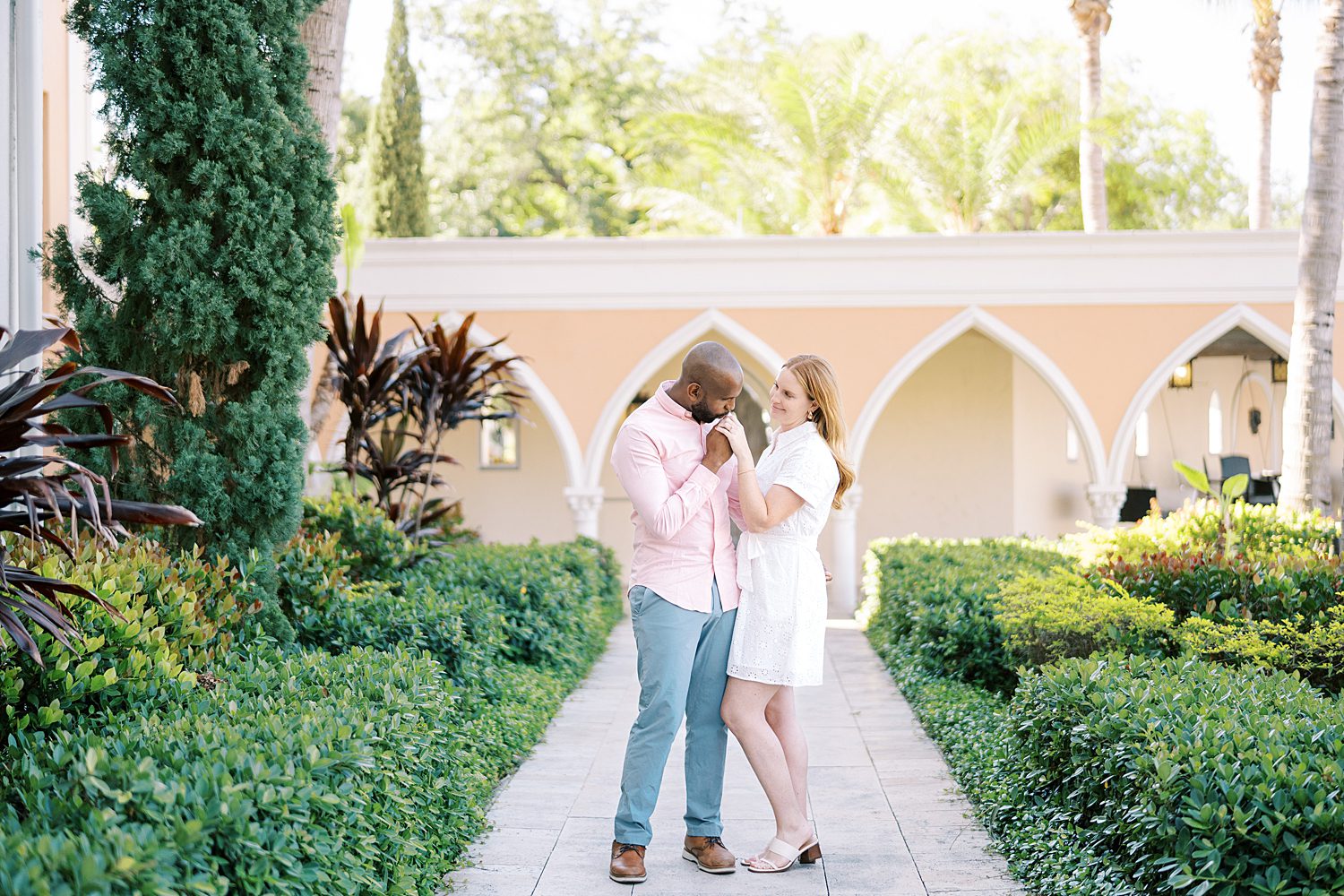 couple holds hands on man's chest during Tampa FL engagement session 