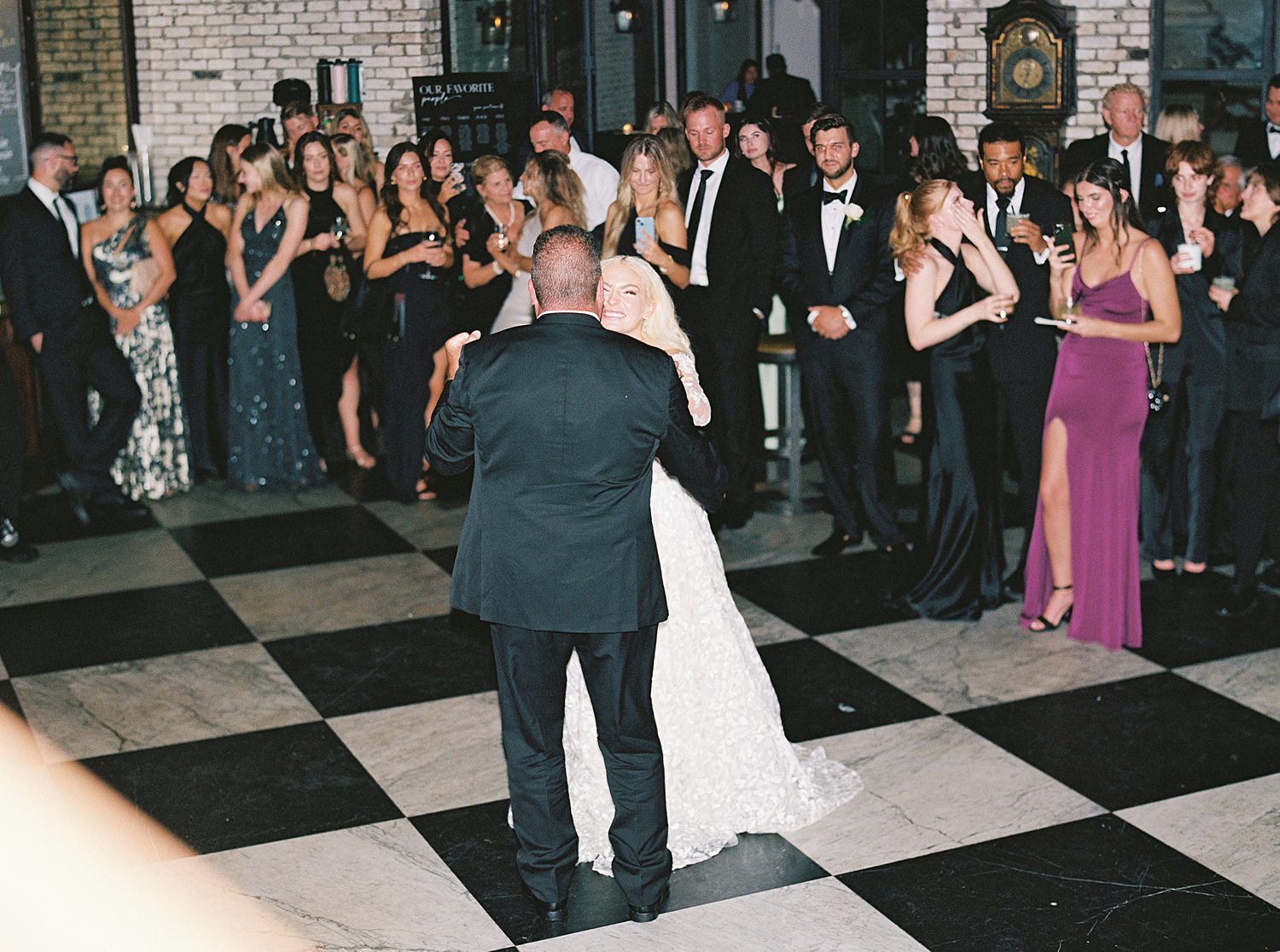 newlyweds dance on checkered floor at the Oxford Exchange