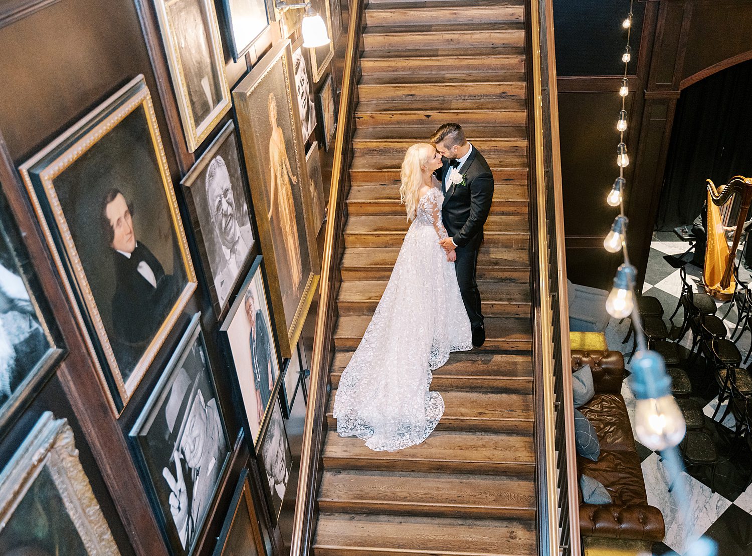 bride and groom stand on staircase inside the Oxford Exchange