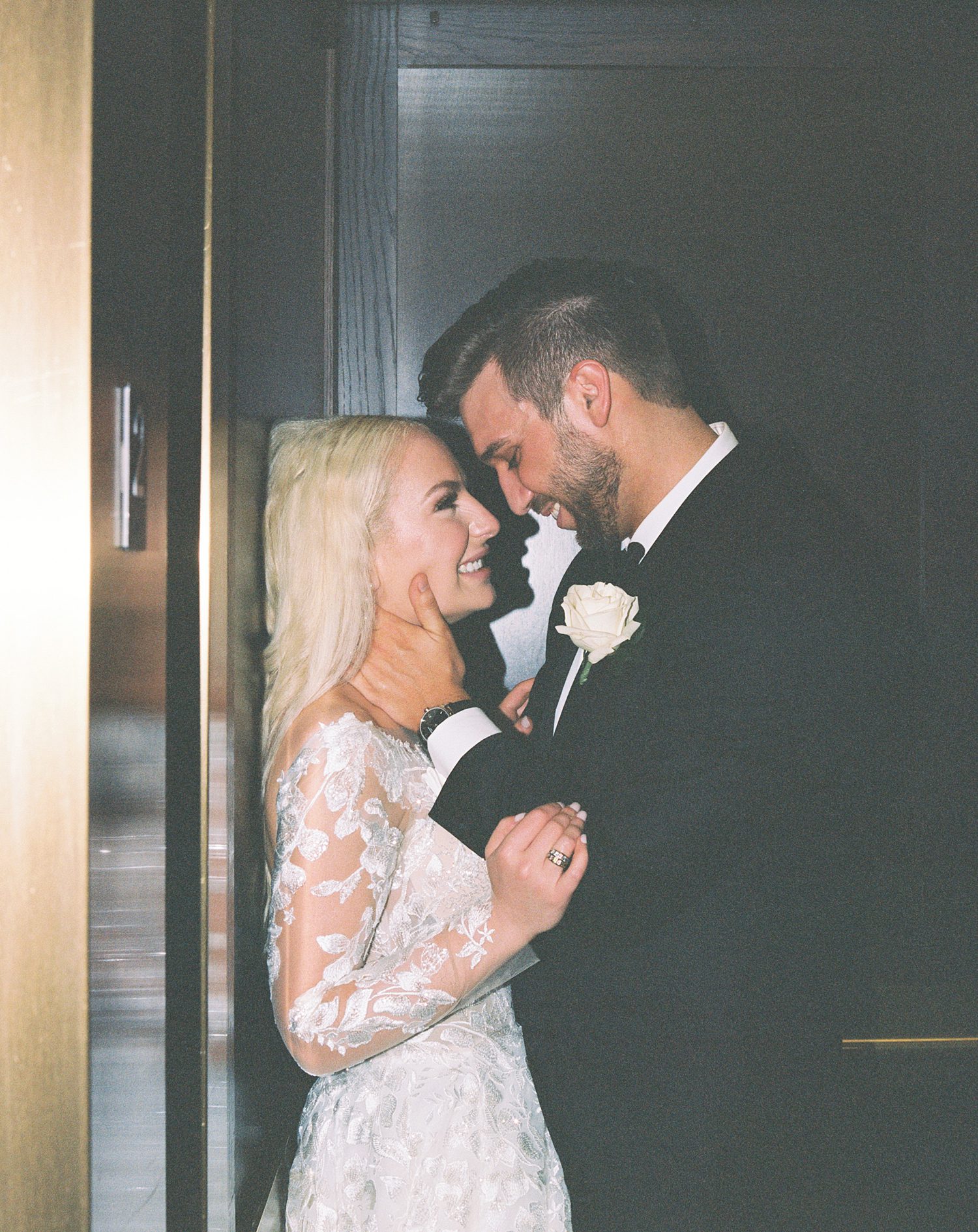 bride and groom lean against elevator door at the Oxford Exchange
