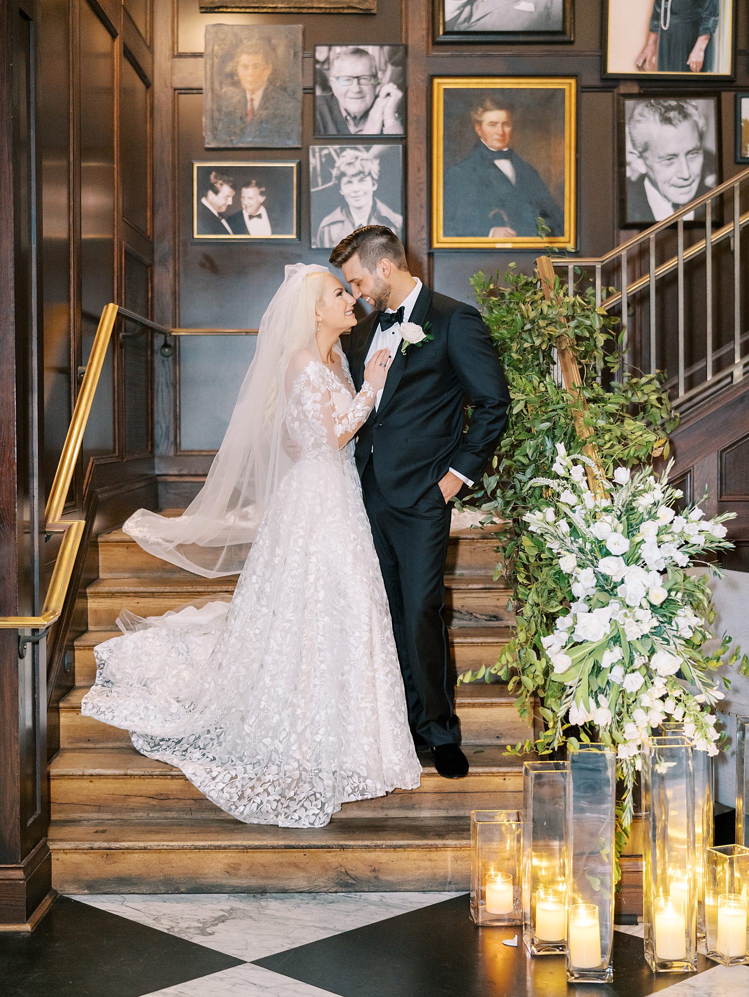 bride and groom stand on steps inside the Oxford Exchange during Tampa wedding