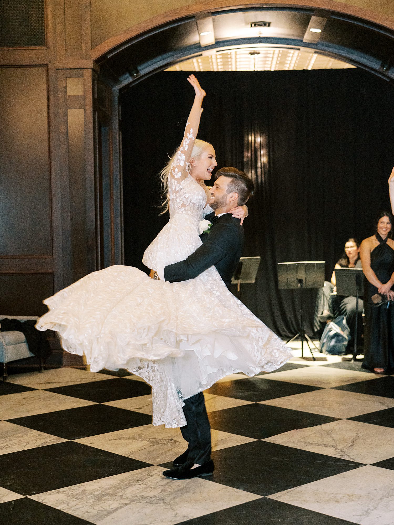 groom twirls bride around during dance in Tampa FL