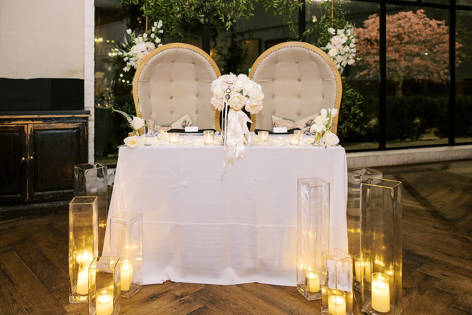 two chairs for sweetheart table with candles at the bottom of the table
