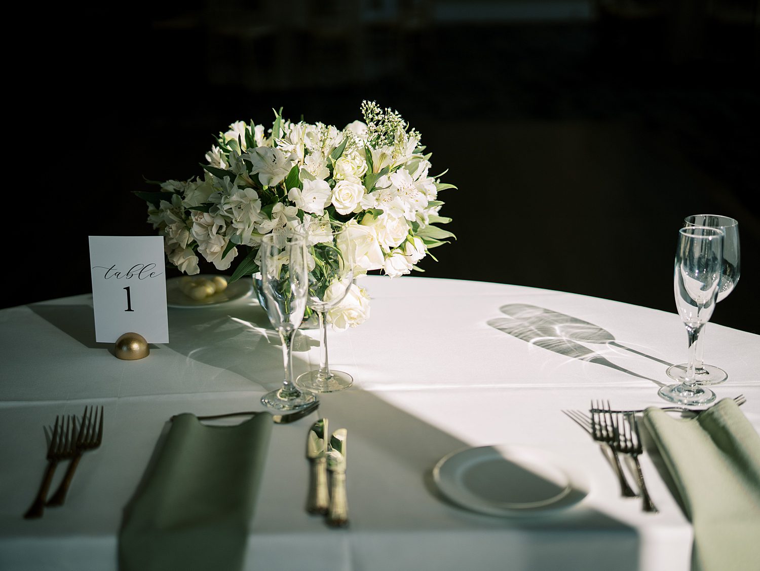 place setting for bride and groom with sage green napkins