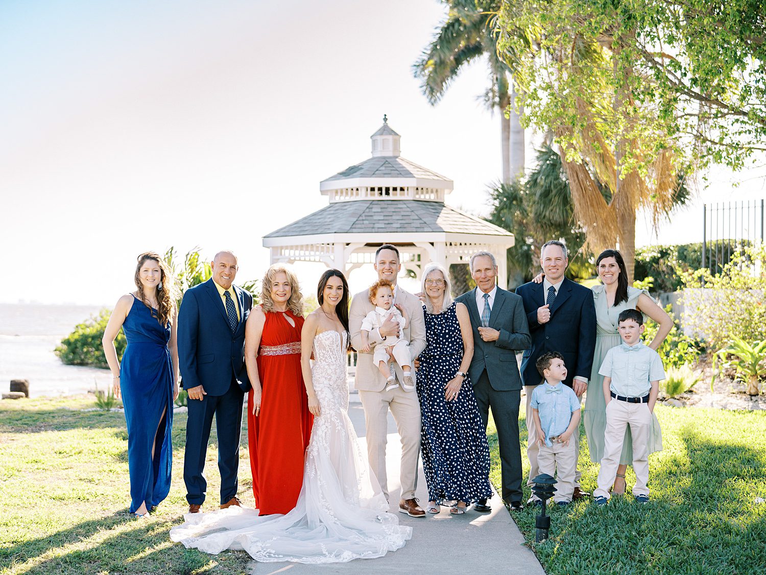 family poses with bride, groom, and their daughter during wedding celebration at the Rusty Pelican Tampa