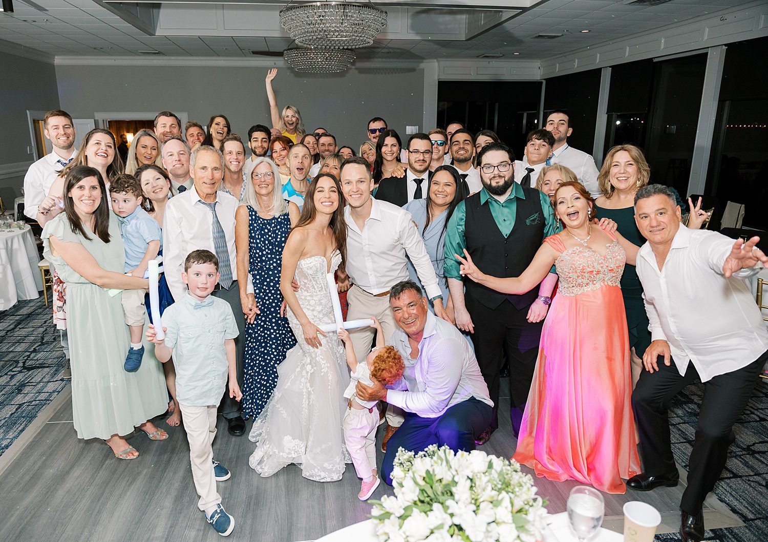 bride and groom pose with guests during reception at the Rusty Pelican Tampa