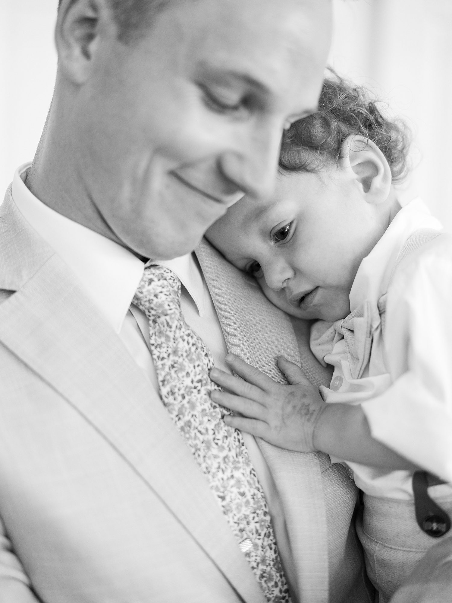 son leans on dad's chest during Tampa wedding day