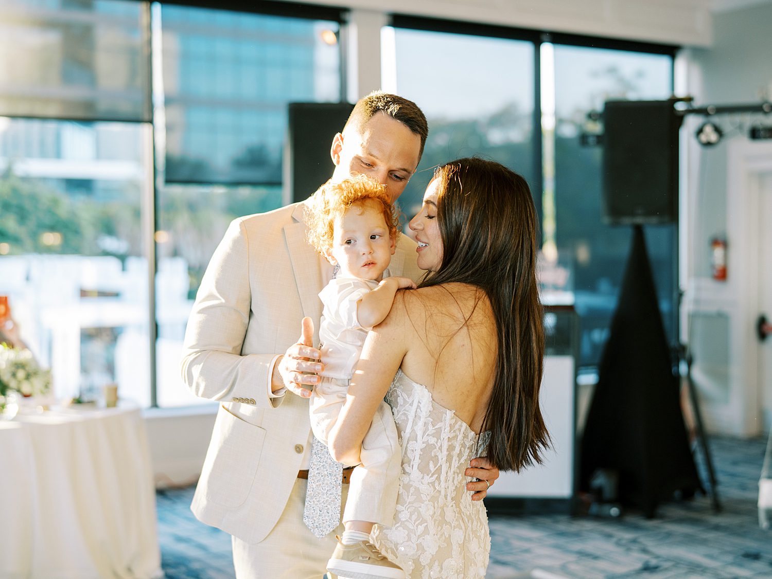 bride and groom dance with son during reception party at the Rusty Pelican Tampa