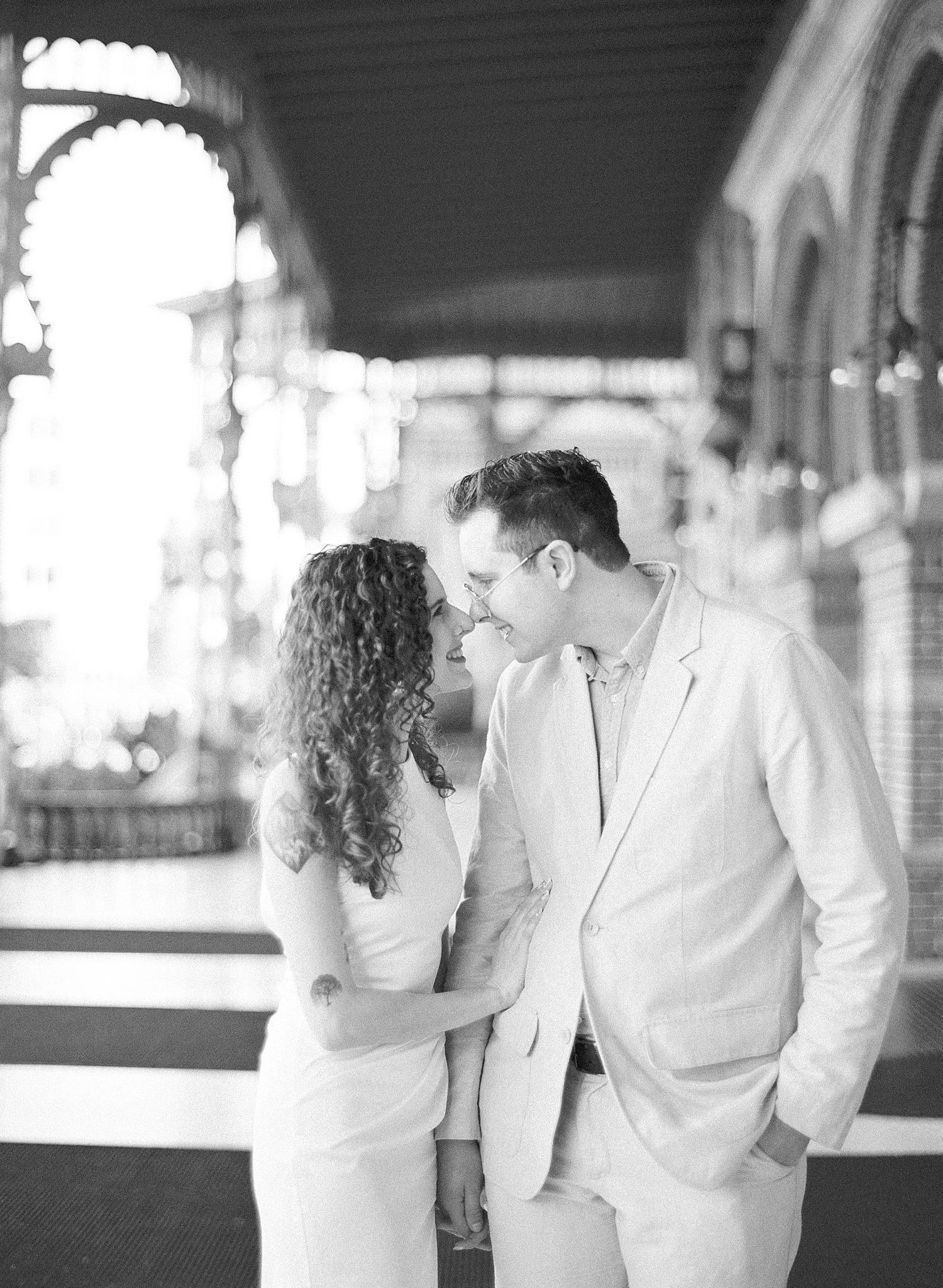 man and woman lean heads together standing on porch at University of Tampa