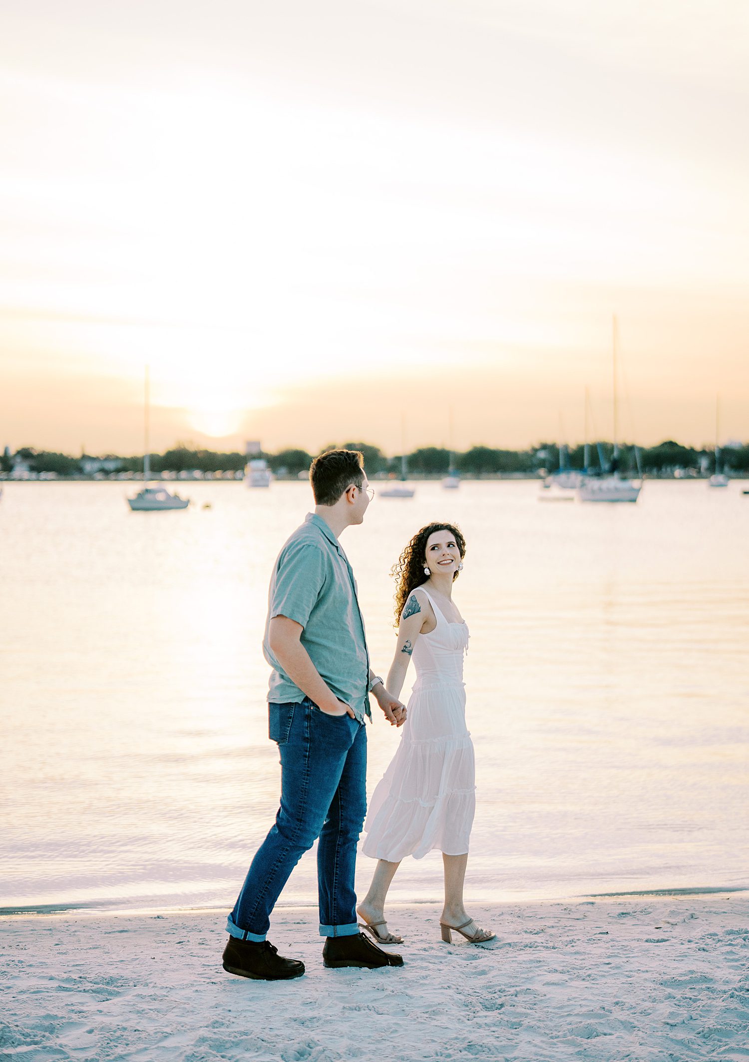 woman leads man across sand on Davis Island Beach 