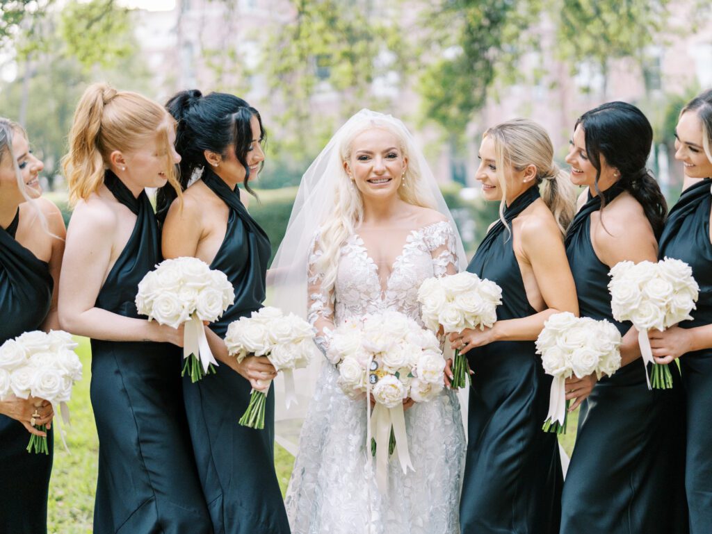 Bride and bridesmaids smiling at each other on wedding day at oxford exchange tampa florida