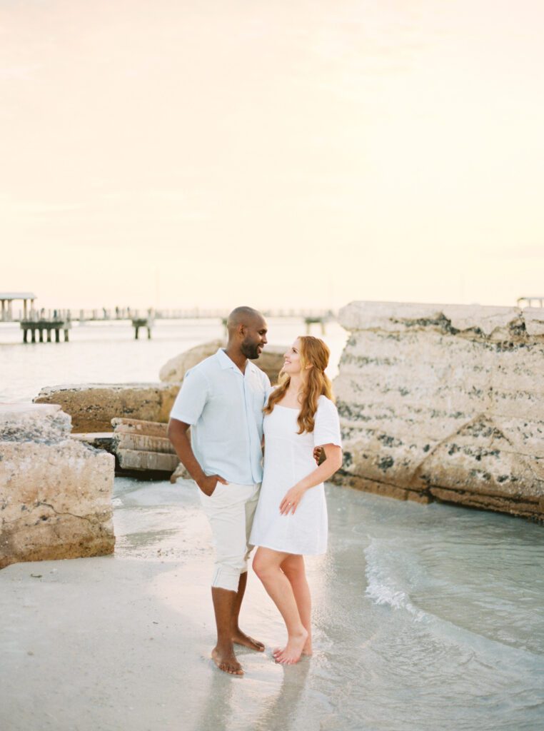 Fort de soto beach engagement Bride and groom looking at each other smiling