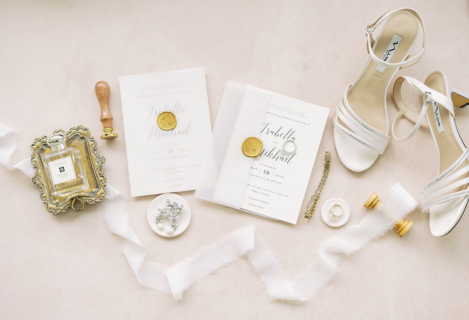 invitation suite with gold wax seal, ribbon and bride's shoes