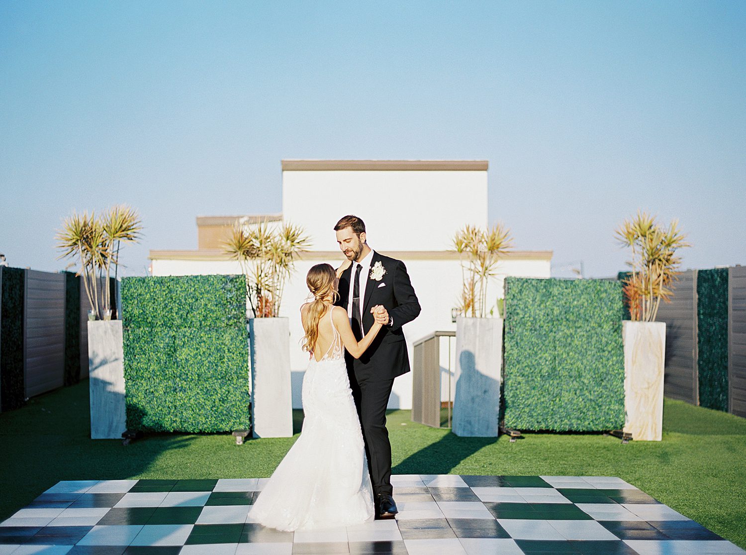 bride and groom dance on checkered floor during Hotel Zamora weddings