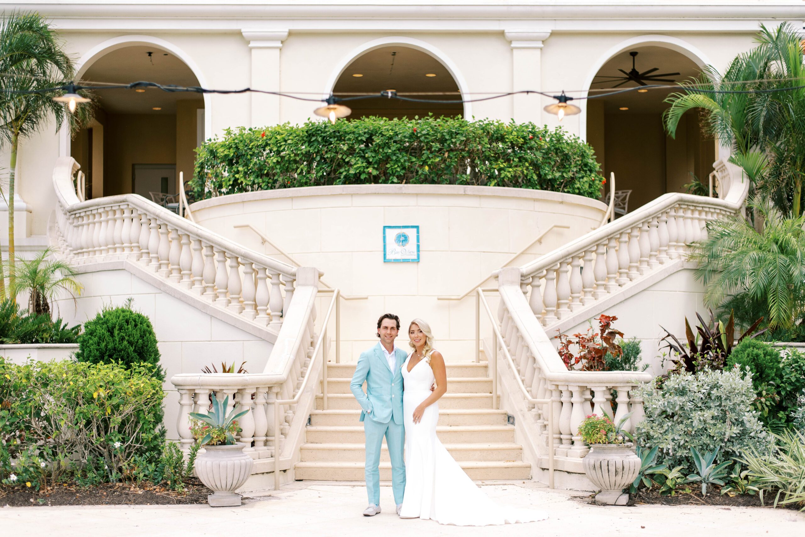 Ritz Carlton Sarasota Weddings Bride & Groom by staircase smiling for the camera