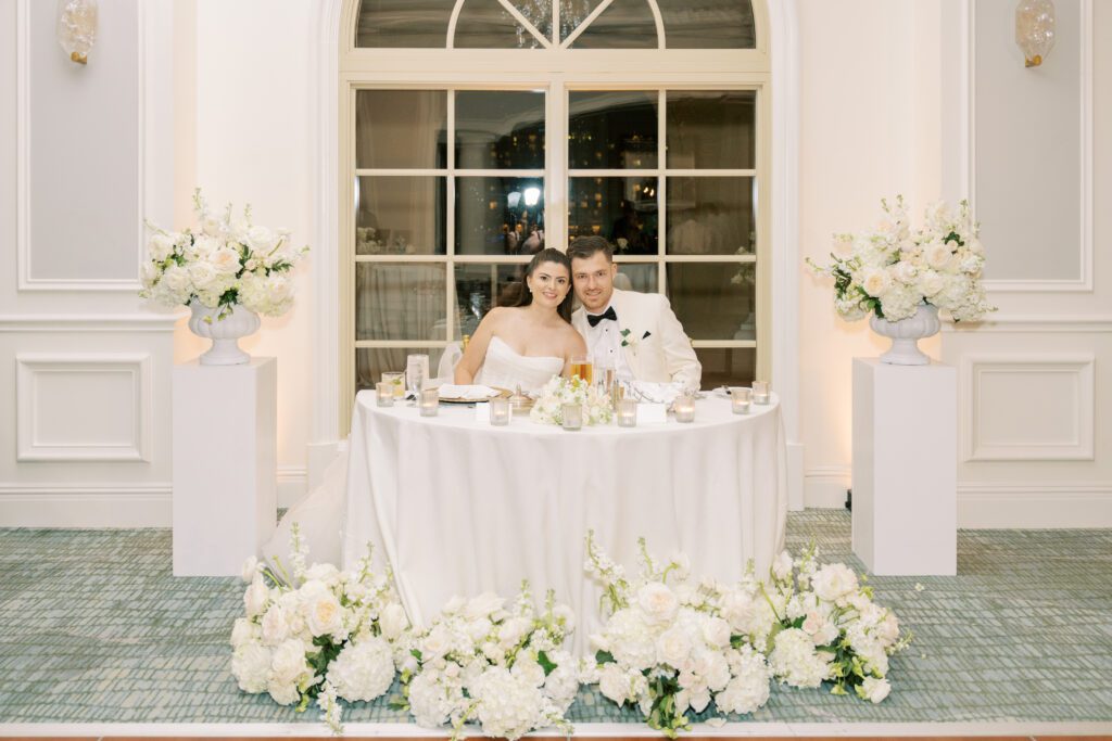 Ritz Carlton Sarasota Wedding Bride & Groom at Ballroom sitting in sweetheart table